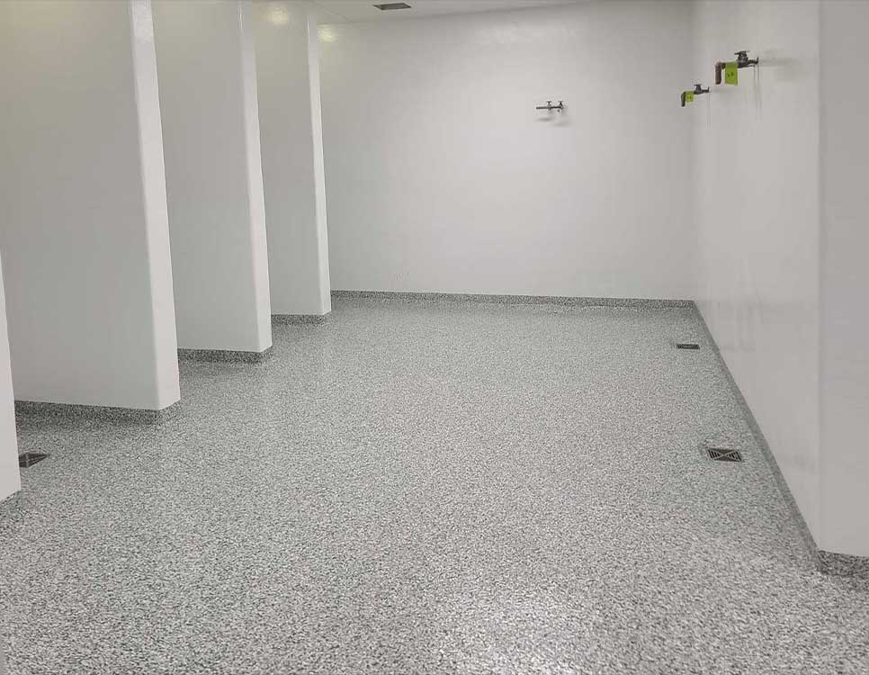 Stranlock Coatings Wall Systems shower room with durable epoxy-coated floors and seamless wall protection for long-lasting, easy-to-clean surfaces.