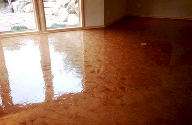 Metallic Residential Floor Coatings in a sunlit room featuring a high-gloss copper-toned finish with swirling patterns and reflective surface detail.