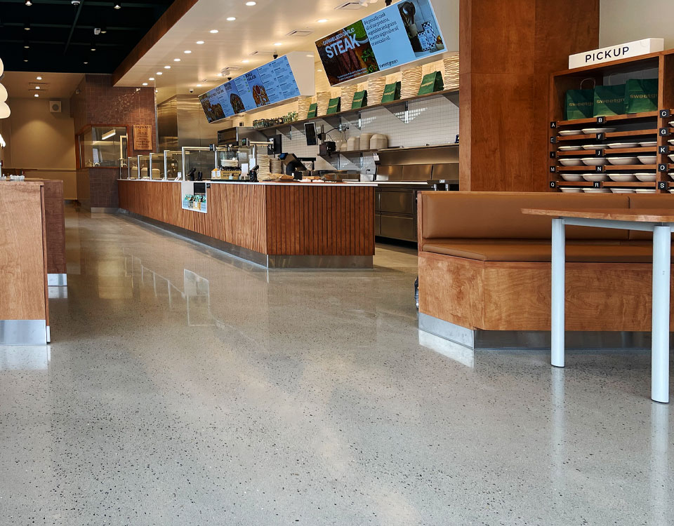Restaurant High Traffic Flooring shown in a fast-casual dining space with polished concrete floors designed for durability, cleanliness, and aesthetic appeal.